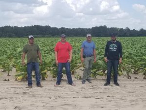 Farm Worker Members pose for a picture in front of one of the fields they harvest 8.22.2019 100 degree weather Picture Chibuzo Petty BB Unity Coalition Trip